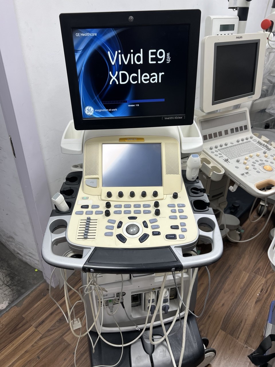 Ultrasound machine with 'Vivid E9 XClear' display in a medical setting